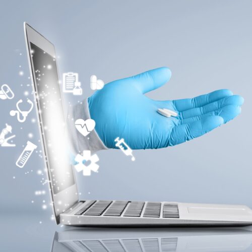 Virtual doctor concept, The doctor's hand protrudes from the laptop screen